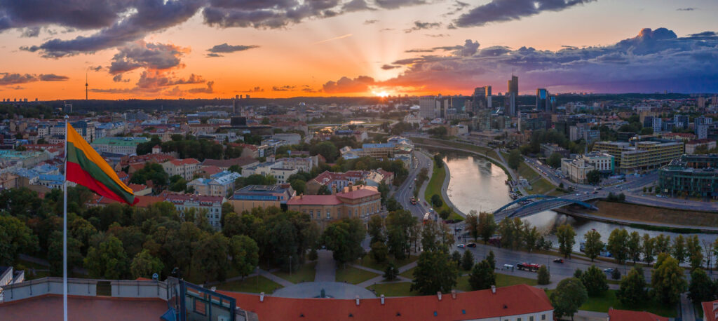 Aerail view of the Lithuanian flag over the old town of Vilnius at sunset. Lithuanian flag photo.
