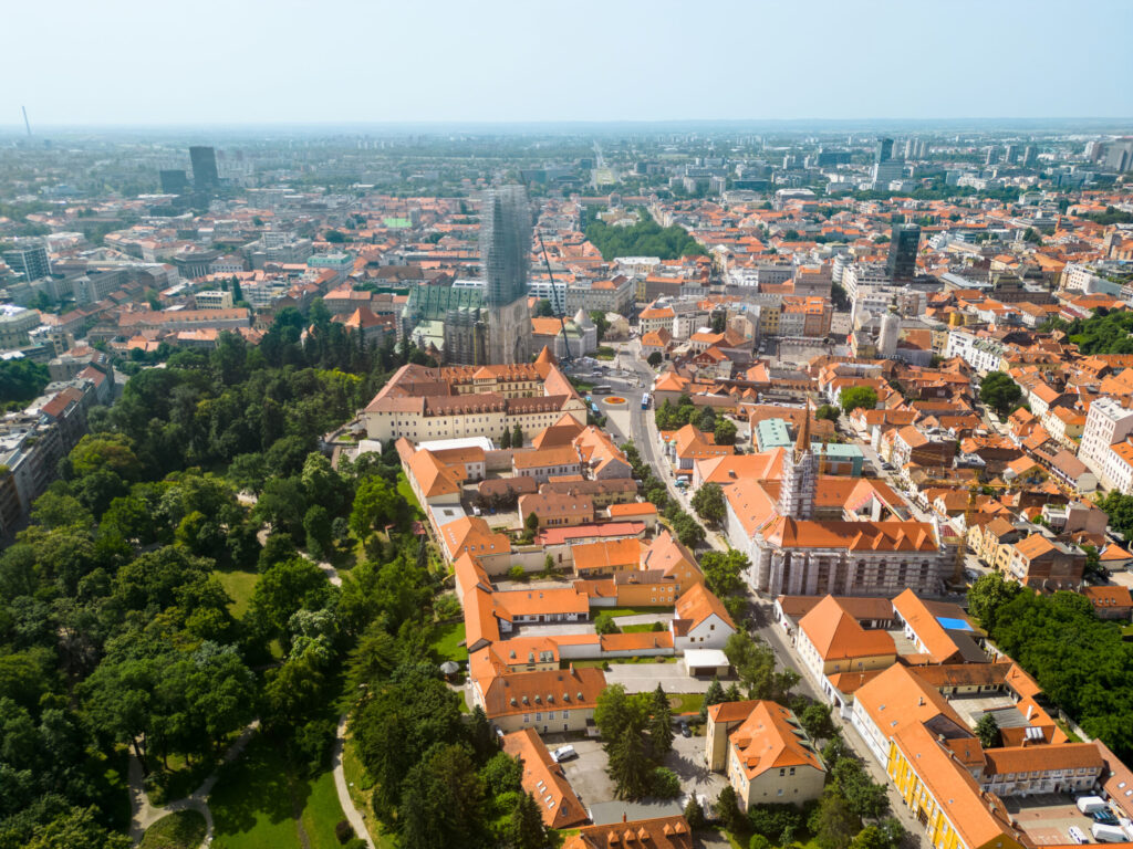 Aerial drone view of Zagreb, Croatia. Historical city centre with multiple old buildings made in national style, Zagreb Cathedral, greenery