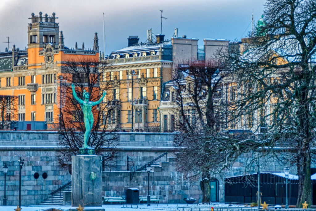 A beautiful view of a sculpture surrounded by trees in a park in Stockholm, Sweden
