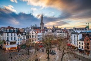 Brussels, Belgium plaza and skyline with the Town Hall tower at dusk.