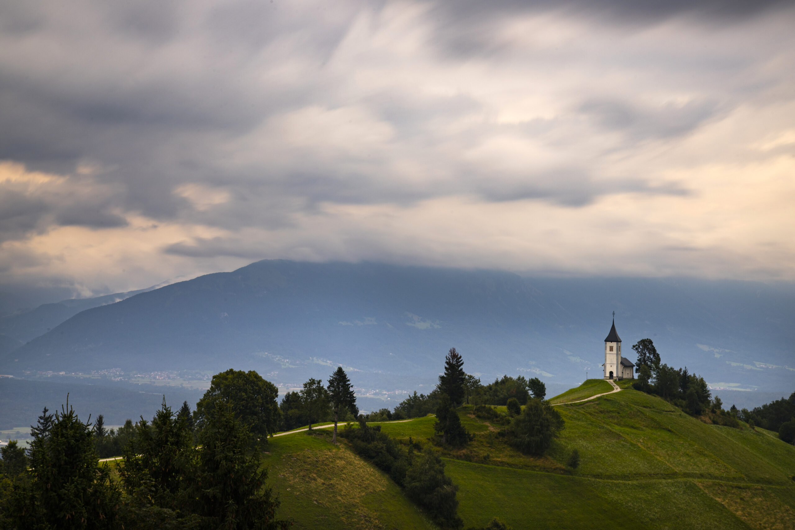 Jamnik, Slovenia. The Jamnik Church is a charming 15th-century chapel in the Kamnik-Savinja Alps near Kranj, breathtaking views of the surrounding mountainous landscape.