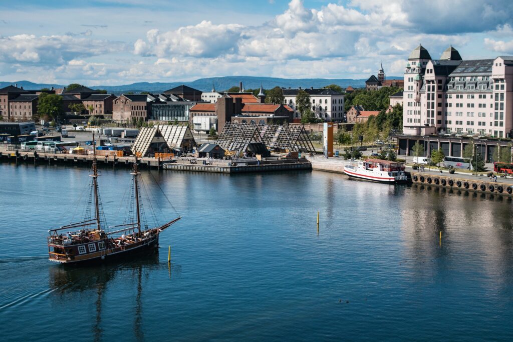 A lot of buildings on the coast of a sea near Akershus Fortress in Oslo, Norway
