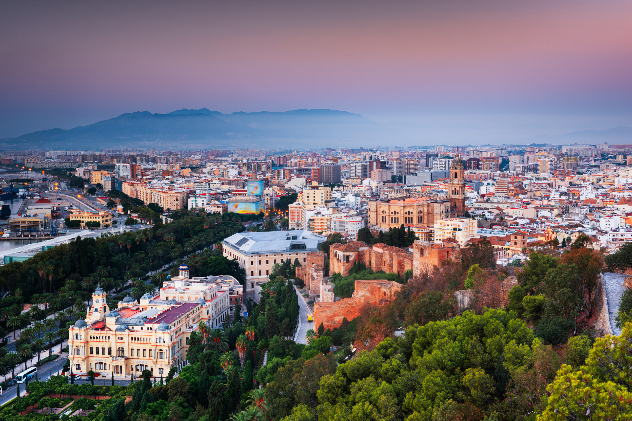 Malaga, Spain cityscape at the Cathedral, City Hall and Alcazaba citadel of Malaga at dusk.