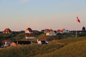 A picturesque scene of white houses on the hill in Lonstrup, Denmark