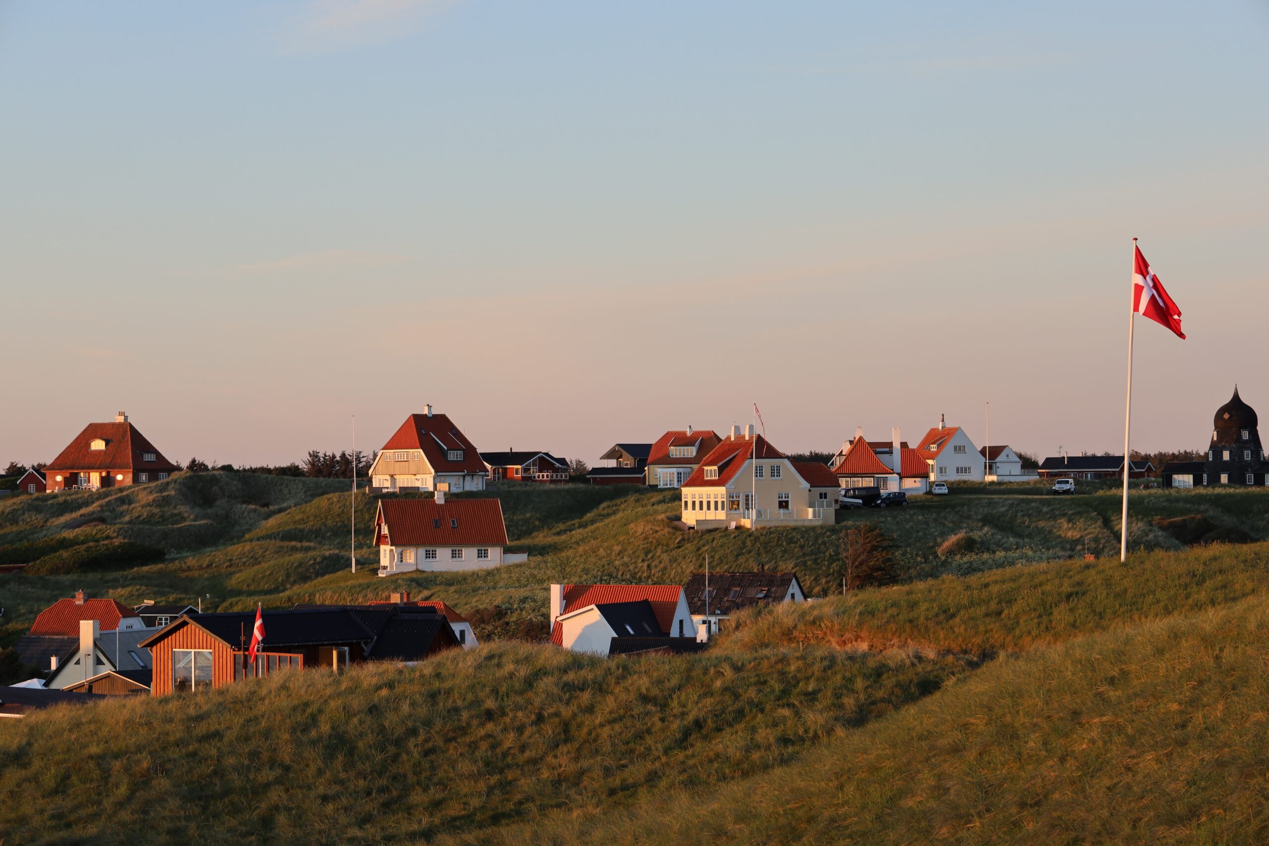 A picturesque scene of white houses on the hill in Lonstrup, Denmark
