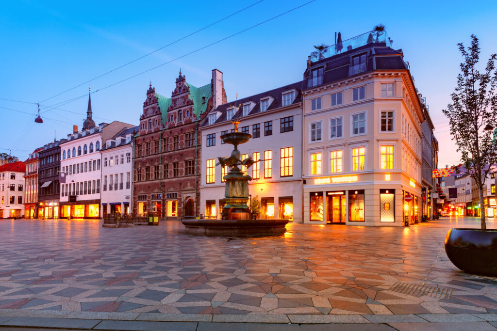 Stork Fountain on the Amagertorv square, Stroget street during morning blue hour, Copenhagen, capital of Denmark