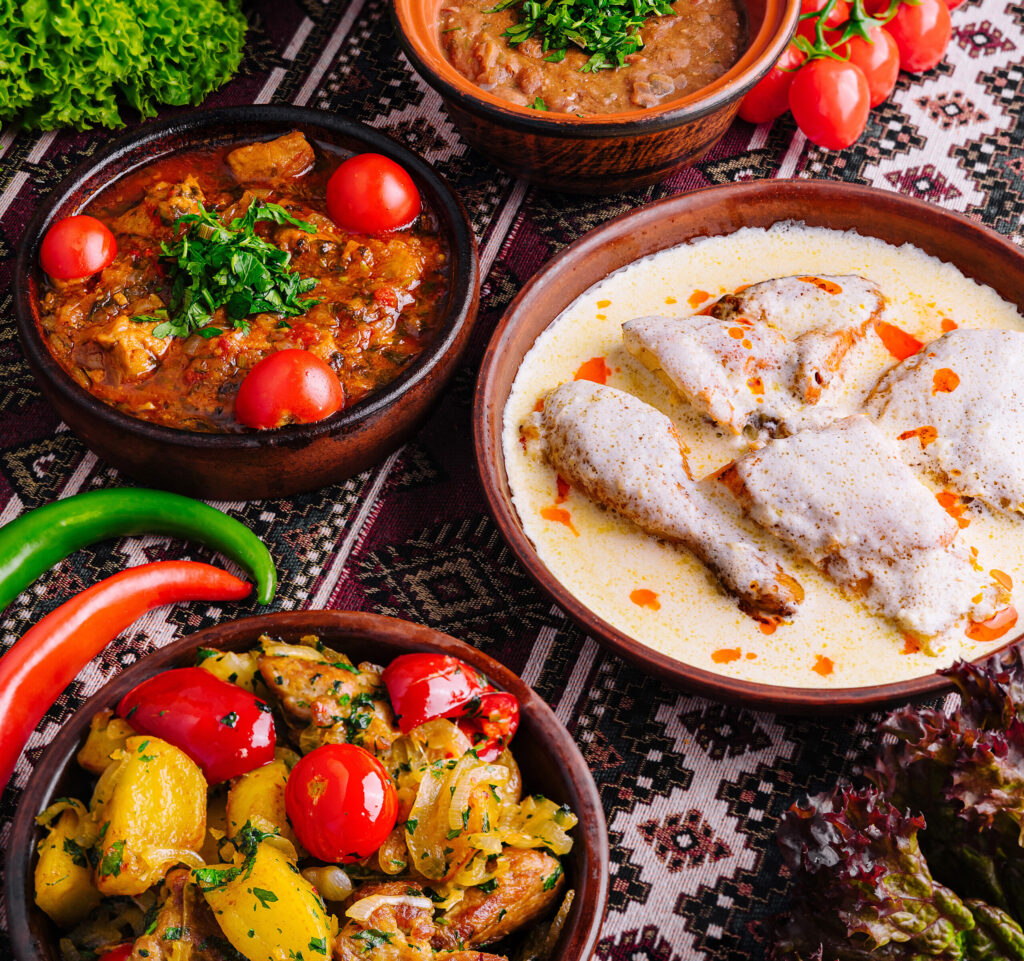 Vibrant display of eastern european dishes with fresh vegetables on a patterned tablecloth