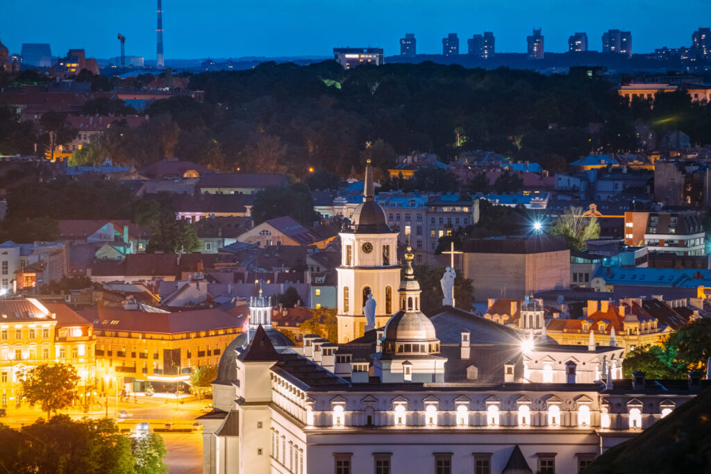 Vilnius, Lithuania, Eastern Europe. Aerial View Of Historic Center Cityscape In Blue Hour After Sunset. Travel View Of Old Town In Night Illuminations. UNESCO. Palace Of The Grand Dukes Of Lithuania