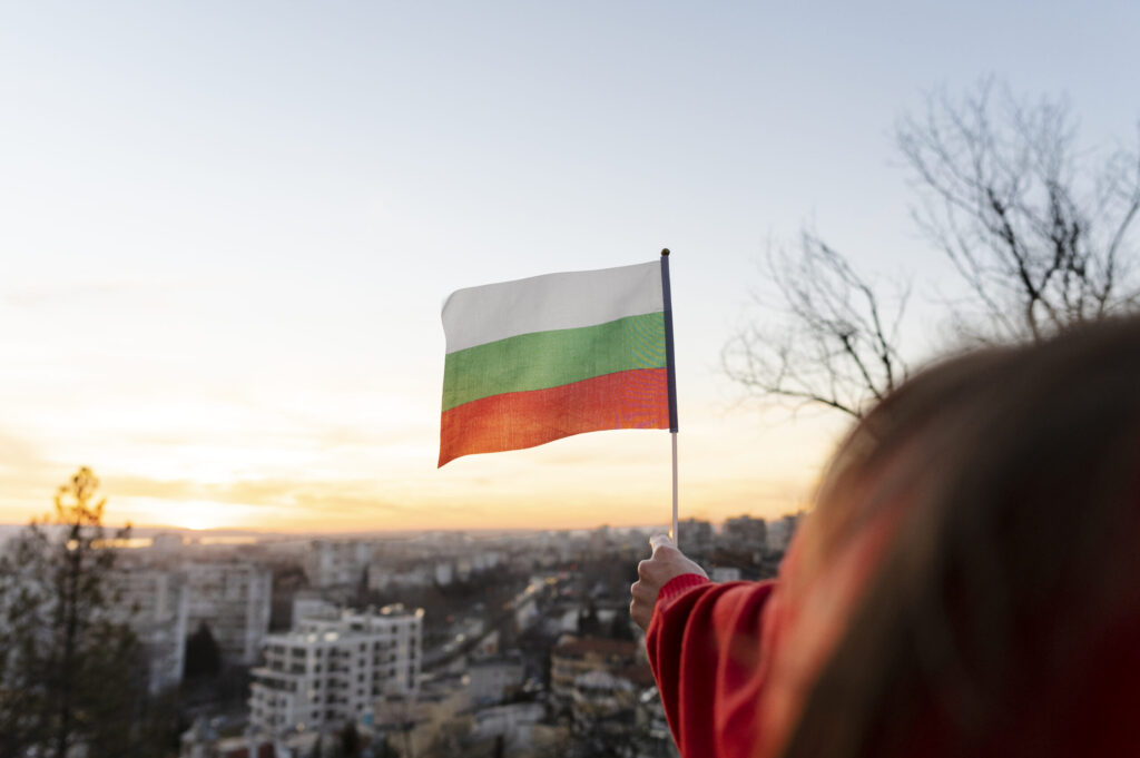 Woman holding Bulgarian flag outdoors – expressing national pride in an open environment