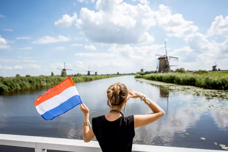 Woman near the old windmills in the Netherlands – enjoying historic Dutch landscape and heritage
