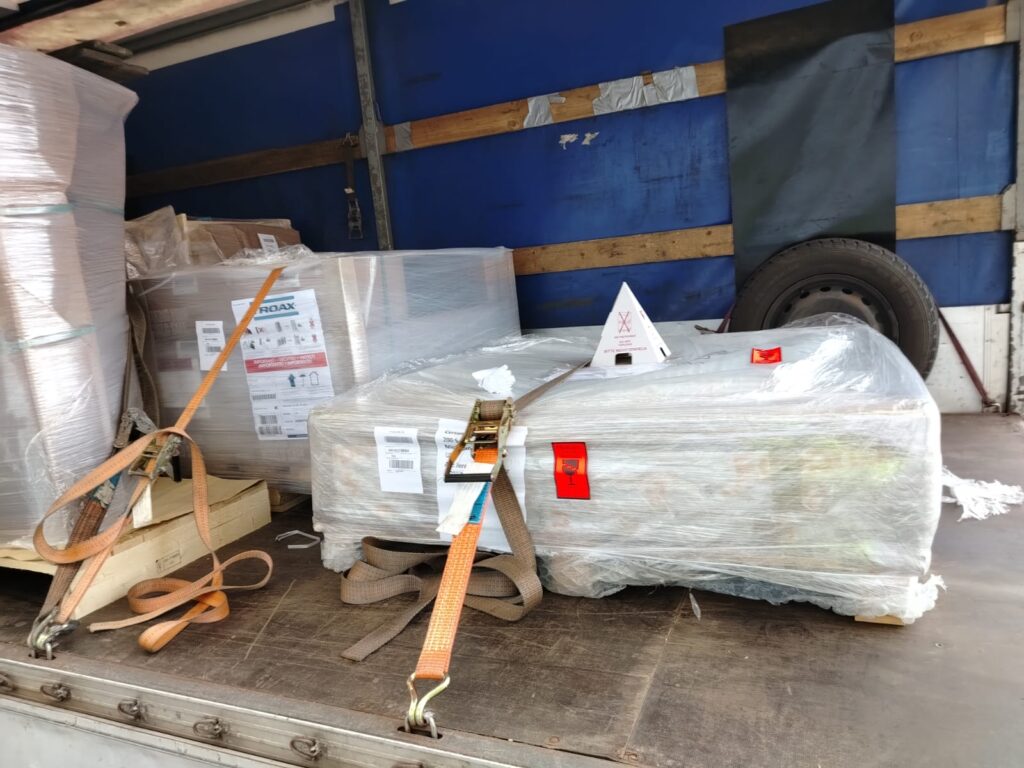 Two shrink-wrapped pallets strapped inside a covered truck, illustrating VanOnsite’s secure loading for international removals UK to Netherlands.