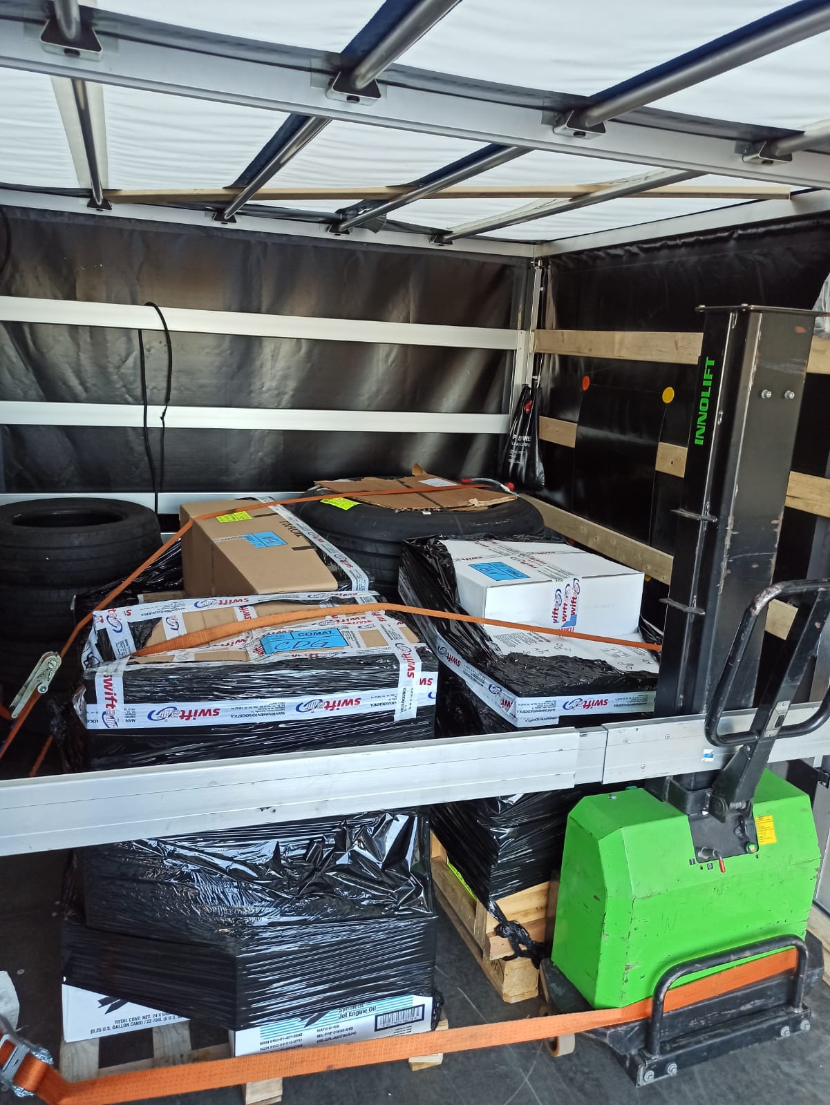 Loaded moving van with securely strapped packages and household items for a last minute relocation.