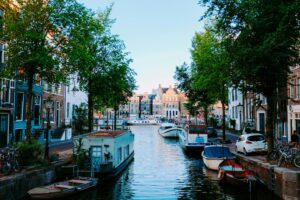 Picturesque canal in the Netherlands with boats and historic houses—visual contrast for lifestyle in the "living in Netherlands vs UK" comparison.