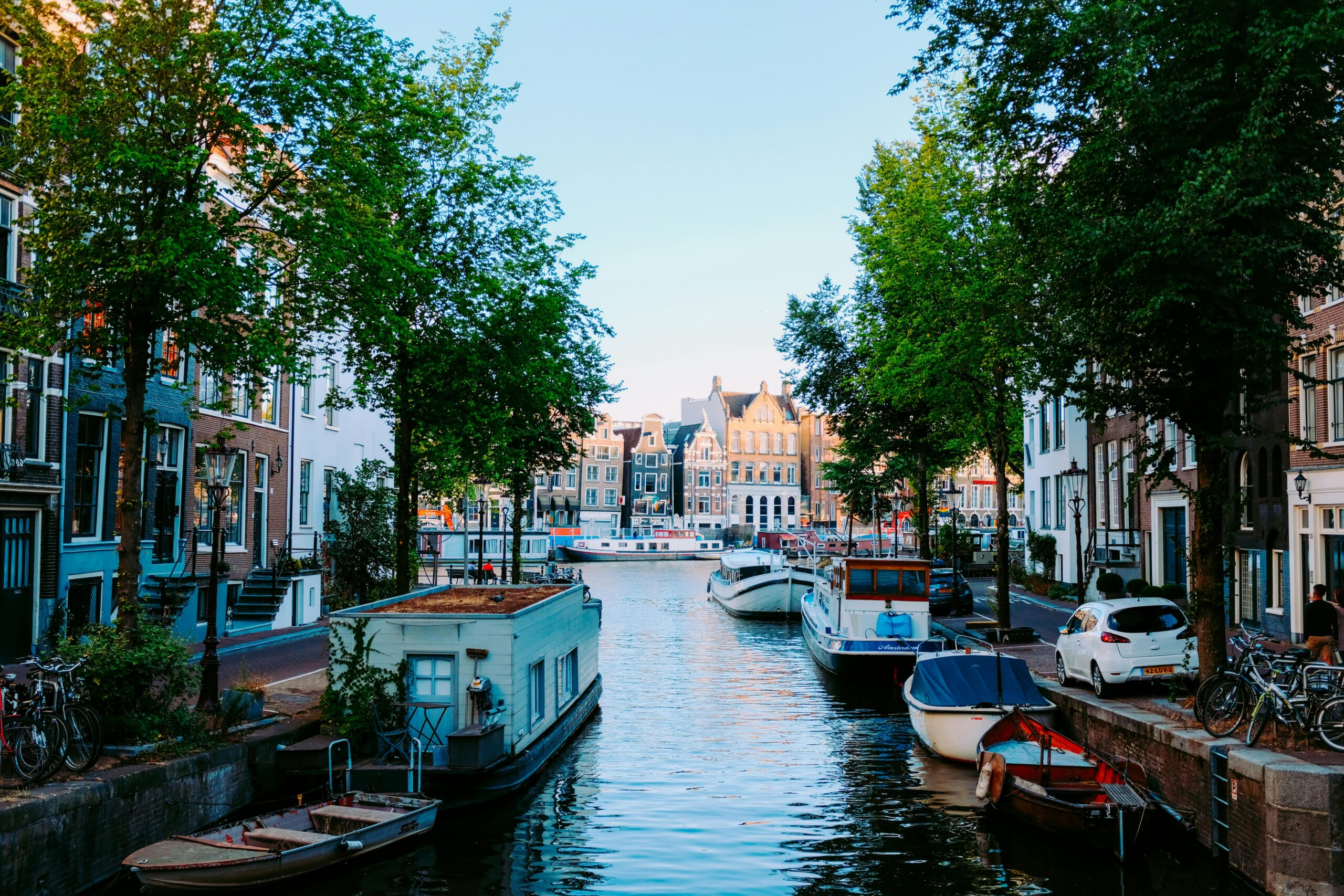 Picturesque canal in the Netherlands with boats and historic houses—visual contrast for lifestyle in the "living in Netherlands vs UK" comparison.