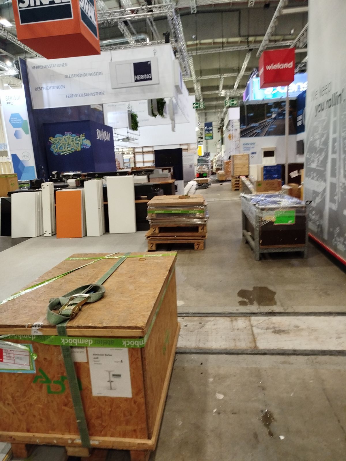 Indoor warehouse space with wooden storage crates and pallets, prepared for long term storage and secure handling of goods.