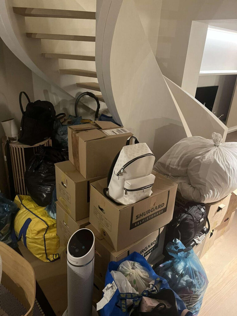 Furniture pieces wrapped in plastic and secured on a pallet outside a building, ready for removals to Holland Netherlands from Spain.