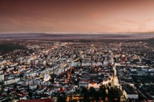 Removals to Romania with VANonsite, showing a city skyline at sunset and highlighting trusted international moving with door to door delivery and secure handling.