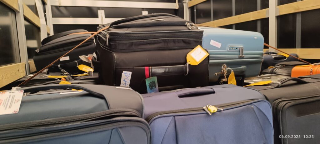 Close up of labeled suitcases stacked inside a moving truck, showing professional luggage transport service for European relocations with VANonsite.