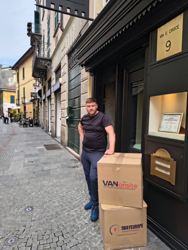 VANonsite moving box delivery at a city address, with packed cartons ready for international removals pickup
