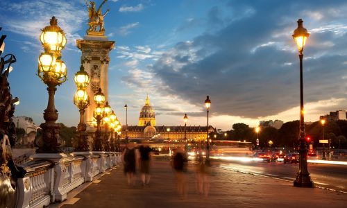 View on Les Invalides from bridge Alexandre III in Paris at sunset, France