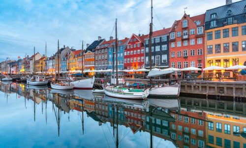 Nyhavn with colorful facades of old houses and old ships in the Old Town of Copenhagen, capital of Denmark.