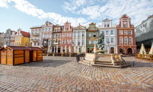 View on the beautiful old buildings with Neptune fountain on the Maket square in Poznan city during the morning light in Poland