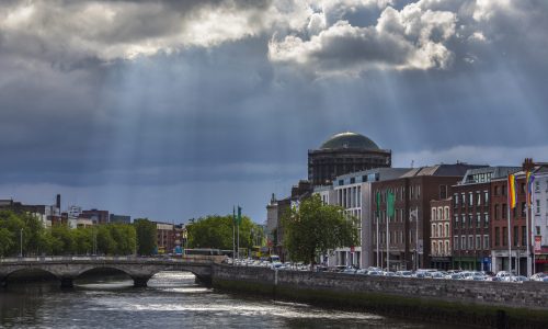 Storm clouds and sunrays over the River Liffey and the city of Dublin in the Republic of Ireland.